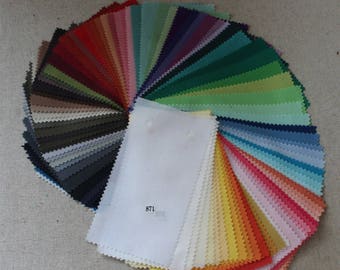 May include: A fabric swatch book featuring a range of colours, including red, green, blue, yellow, and white. The swatches are arranged in a fan shape, with the white swatch in the centre. The text "871" is printed on the white swatch.