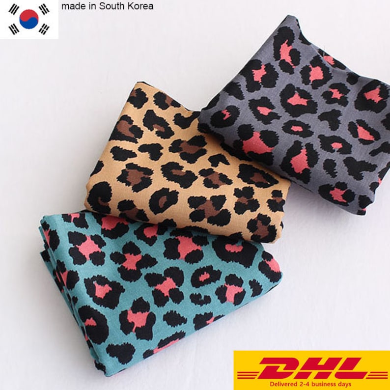 May include: Three fabric swatches with a leopard print pattern. The swatches are in teal, brown, and gray with pink accents.