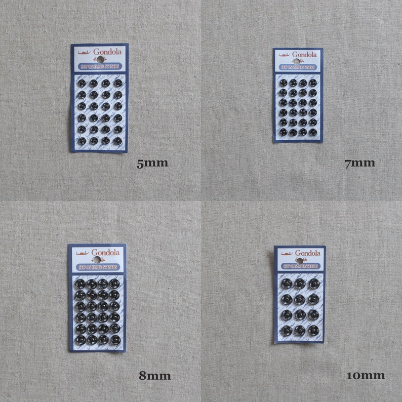 May include: Four packs of black metal snap fasteners in different sizes: 5mm, 7mm, 8mm, and 10mm. Each pack has a white label with the text "Gondola" and "Snap Fasteners".