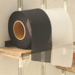 May include: A roll of black tape with a textured surface, and a roll of white tape, both on a small wooden shelf. The black tape has a tan-colored core. The white tape is partially unrolled.