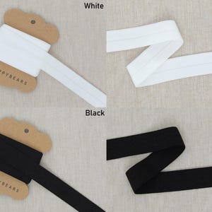 May include: White and black elastic ribbon spools. The white ribbon is folded and displayed in two different ways. The black ribbon is also folded and displayed in two different ways. The text "White" and "Black" are displayed in the image.