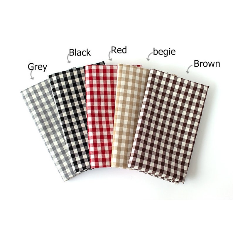 May include: Five folded fabric squares in grey, black, red, beige, and brown, each with a classic gingham check pattern. The colors are labeled above each fabric square. The fabrics are arranged in a fan shape.