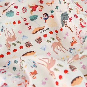 May include: White fabric with a repeating pattern of Snow White, the Seven Dwarfs, woodland animals, and other elements from the Disney movie Snow White and the Seven Dwarfs. The fabric is white with red, green, brown, and blue accents. The text "© Disney" is printed on the fabric.
