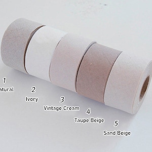May include: Five rolls of adhesive tape arranged in a row, labelled with numbers and colours: 1 Natural, 2 Ivory, 3 Vintage Cream, 4 Taupe Beige, and 5 Sand Beige. Each roll features a textured surface and a central cardboard core.