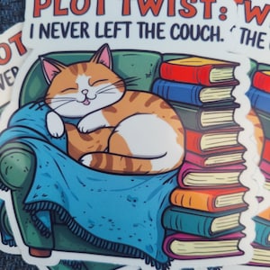 May include: A sticker featuring a cartoon cat lounging on a green couch with a blue blanket, surrounded by a stack of colorful books. The text reads "Plot Twist: I never left the couch."