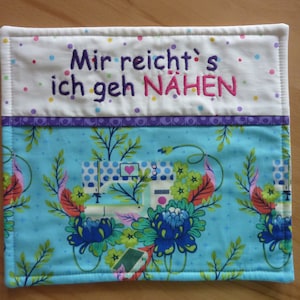 May include: A blue and white fabric coaster with a sewing machine design and the text "Mir reicht's ich geh NÄHEN".
