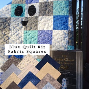 May include: A quilt featuring a ghost design in shades of blue, gray, and white, accompanied by a stack of assorted fabric squares and a book titled The Little Ghost Who Was a Quilt. The text Blue Quilt Kit Fabric Squares is visible.
