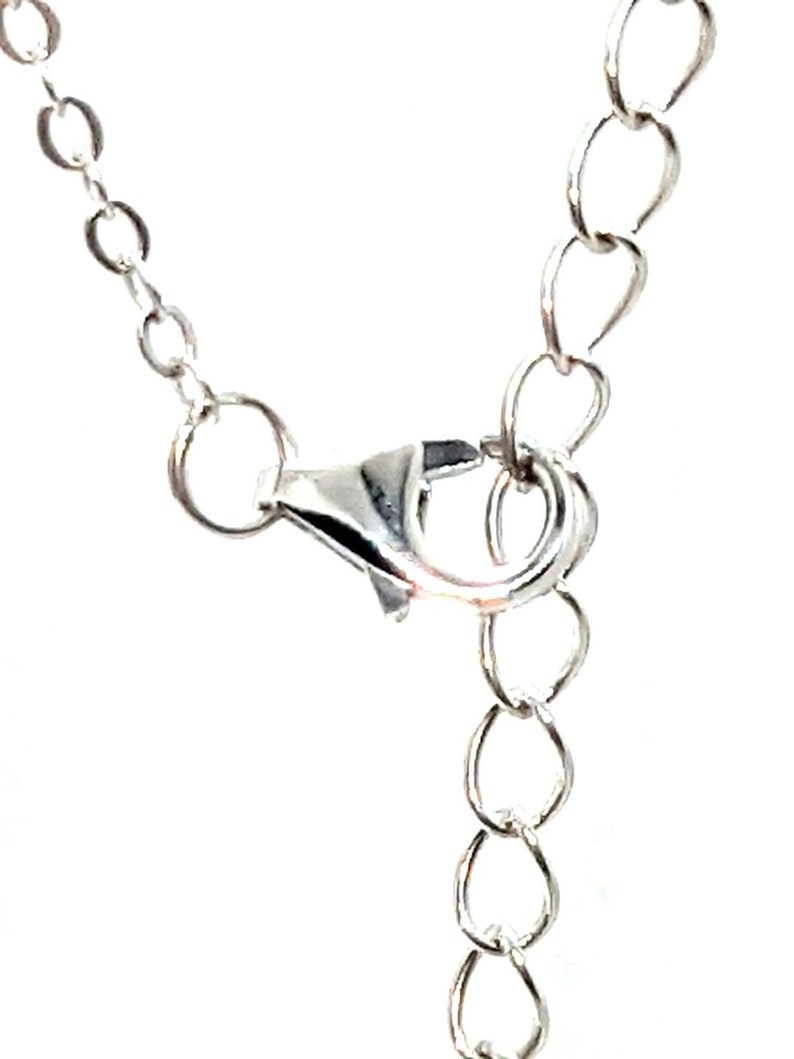 May include: Silver chain necklace with a lobster clasp closure.