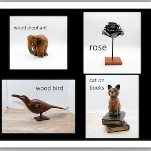 May include: A collage of four images featuring wooden sculptures. Includes a brown elephant, a black metal rose on a wooden stand, a brown bird, and a cat on books. The text "wood elephant", "rose", "wood bird", and "cat on books" are included.
