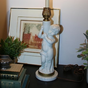 Vintage 1950s-1970s ornate Bisque cherub baby with Greek urn lamp marble base and brass metal accent,  Hollywood Regency style boudoir lamp