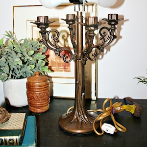 May include: A set of three ceramic mugs with a speckled, matte finish. The mugs are in shades of cream, light gray, and dark gray. Each mug has a simple, modern design and a rounded handle. The mugs are likely for coffee or tea.