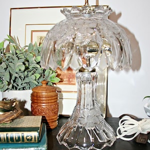 May include: A set of three ceramic vases in varying heights. The vases are white with a textured, ridged design. The tallest vase is approximately 10 inches tall, the medium vase is 8 inches, and the smallest is 6 inches.