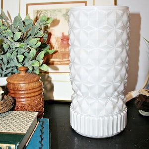 May include: A set of three ceramic mugs with a speckled, matte finish. The mugs are in shades of cream, light gray, and dark gray. Each mug has a simple, minimalist design, perfect for coffee or tea.