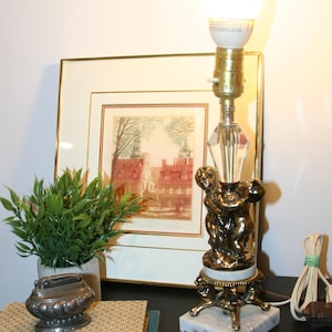 Vintage 1970s Crystal clear glass and gold metal cherub babies holding hands lamp with marble base,  Hollywood Regency style lamp