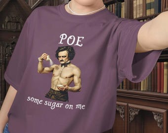 May include: A purple t-shirt featuring a graphic of Edgar Allan Poe sprinkling sugar, with the text "POE" above and "some sugar on me" below. The image is a parody of a famous painting.