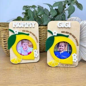 May include: Two wooden photo frames with a lemon design. One frame says "MOMMY" and the other says "GIGI". Both frames have the text "YOU ARE MY MAIN SQUEEZE". The frame also has the text "Love your sweetie".