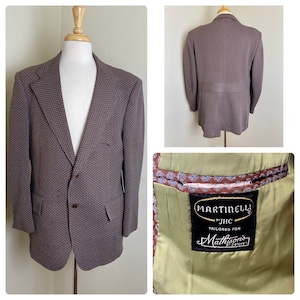 May include: A brown and blue patterned blazer with a two-button closure, notched lapels, and two front pockets. The blazer is displayed on a mannequin. The interior lining is olive green. The label reads "MARTINELLI by JHC Tailored for Mathison's of Ottawa."
