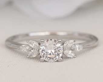 Platinum and man made diamond round & marquise solitaire engagement ring