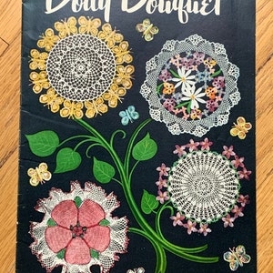 May include: A vintage booklet titled "Doily Bouquet" with a black background and illustrations of four crocheted doilies. The doilies are decorated with butterflies and flowers. The booklet is from Star Book No. 71 and costs 10 cents.