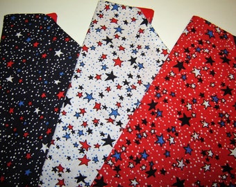 May include: Three fabric strips with a white background and red, blue, and black stars. The fabric is perfect for quilting, crafts, and other projects.
