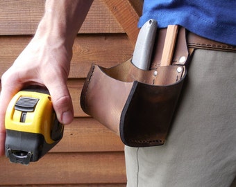 Tape Bag with pockets. This tool belt side pouch is a must for keeping up with your tape measure, pencil  and box knife.