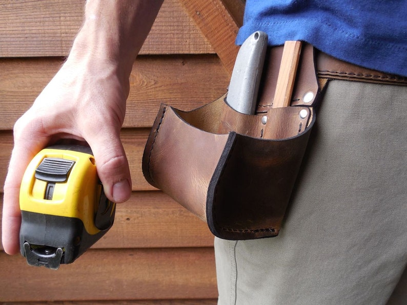 Tape Bag with pockets. This tool belt side pouch is a must for keeping up with your tape measure, pencil and box knife.
