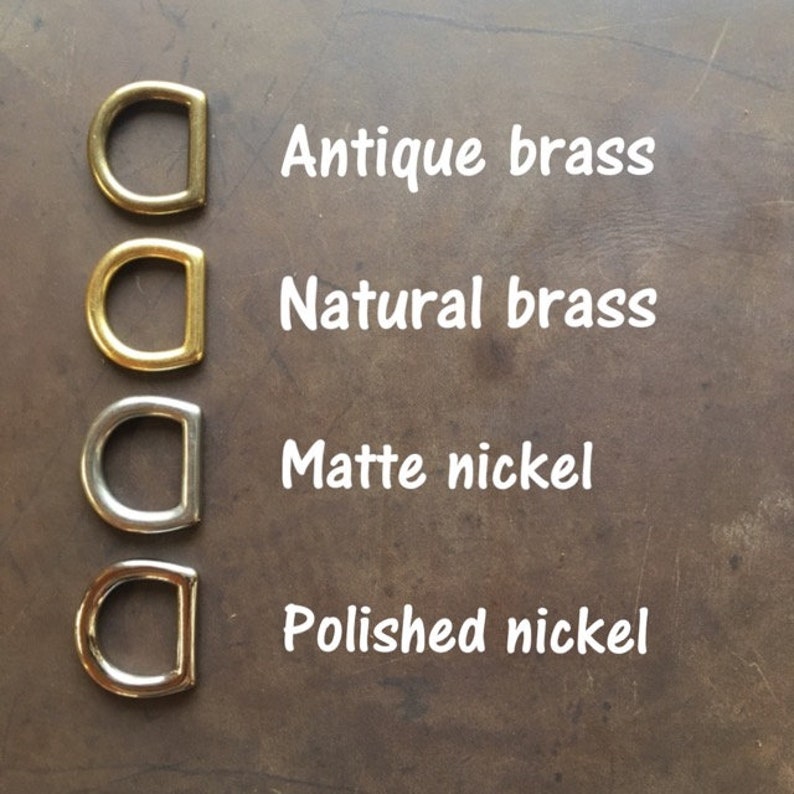 May include: Four metal D-rings in different finishes: antique brass, natural brass, matte nickel, and polished nickel.