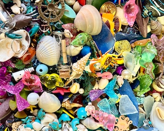 May include: A vibrant collection of nautical-themed trinkets and decorative elements. The image features seashells, starfish, pearls, and various sea creature charms in shades of blue, pink, and yellow. A ship's wheel and anchor add to the maritime theme.