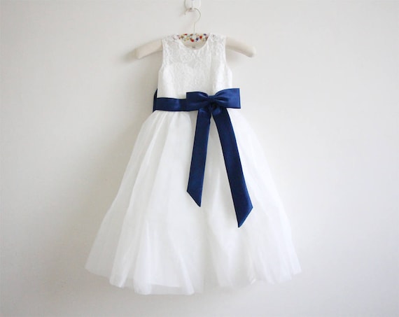 girls in white dresses with blue satin sashes Girls in white dresses with blue satin sashes. Snowflakes that stay on my nose and eyelashes. Silver white winters that melt into springs These are a few of my favorite things we