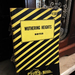May include: A black and yellow striped CliffsNotes book cover with the title "Wuthering Heights Notes" and a price tag of $1.00. The book is published by CliffsNotes Incorporated, Bethany Station, Lincoln 5, Nebraska.