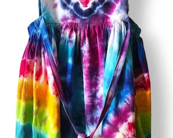 May include: A tie-dye dress with a heart design on the bodice. The dress is made of a soft, comfortable fabric and has a tie at the waist.