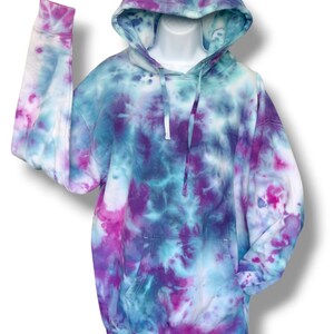 May include: A tie-dye hoodie in shades of blue, purple, and pink. The hoodie has a drawstring hood and a kangaroo pocket.