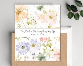 May include: A floral greeting card with a watercolor design featuring peach, pink, and purple flowers. The card includes the text "The Lord is the strength of my life. Psalm 27:1" on a white banner. The card is placed in a brown envelope.