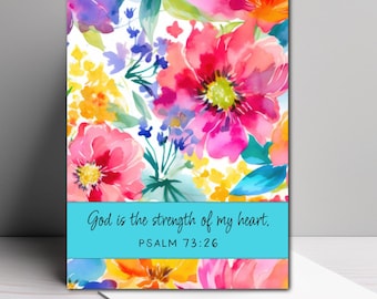 May include: A rectangular greeting card featuring a vibrant watercolor floral pattern with pink, orange, yellow, and blue flowers. A horizontal turquoise band across the lower section contains the black text: God is the strength of my heart. PSALM 73:26.