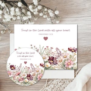 May include: A rectangular card and a circular sticker featuring a watercolor floral arrangement in shades of pink, purple, and white. Both items display the text "Trust in the Lord with all your heart. PROVERBS 3:5" and a small pink heart.