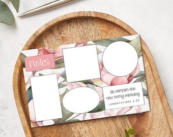 May include: A floral-themed notepad with blank spaces for notes and a quote from Lamentations 3:23. The notepad features pink and green watercolor flowers and the word "Notes" in a pink box. A silver pen rests on a wooden tray.