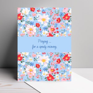 May include: A blue card with a floral pattern and the text "Praying... for a speedy recovery."