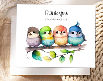May include: A white greeting card featuring the text Thank you and COLOSSIANS 1:3 above a watercolor illustration of four small, colorful birds perched on a brown tree branch with green leaves. The birds are purple, green, orange, and blue.