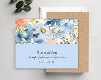 May include: A rectangular greeting card featuring a watercolor floral design with blue and peach flowers on the top half and a solid light blue bottom half. The text reads: I can do all things through Christ who strengthens me. PHILIPPIANS 4:13.