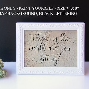 May include: A white framed print with a vintage map background and black lettering that reads "Where in the world are you sitting?" The print is 7 inches by 5 inches.