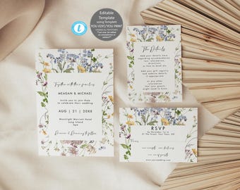 May include: A floral wedding invitation suite with a white background and a watercolor design of blue, yellow, and purple flowers. The invitation includes the couple's names, wedding date, and location. The RSVP card includes the date, address, and website. The details card includes instructions for guests to add their own information.