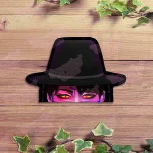 May include: A black fedora hat with a purple and gray design, partially obscuring a pair of glowing orange eyes. The image is set against a wooden background, with green ivy leaves and vines framing the edges.