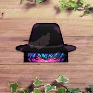 May include: A black fedora-style hat with a distressed design, partially obscuring a stylized face with blue hair and glowing orange eyes. The image is set against a wooden background with green foliage.