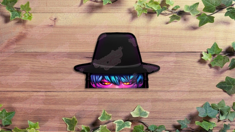 May include: A black fedora-style hat with a distressed design, partially obscuring a stylized face with blue hair and glowing orange eyes. The image is set against a wooden background with green foliage.