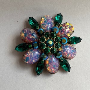 May include: A vintage brooch featuring a cluster of iridescent pink and yellow oval stones surrounded by dark green faceted stones.