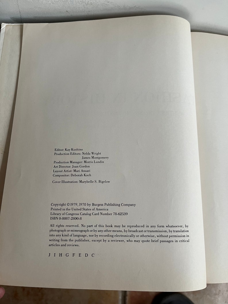 May include: A book with a white cover and black text. The title of the book is not visible. The text on the cover includes the copyright information, the publisher, and the Library of Congress Catalog Card Number. The text also includes the ISBN number and a statement about the copyright.