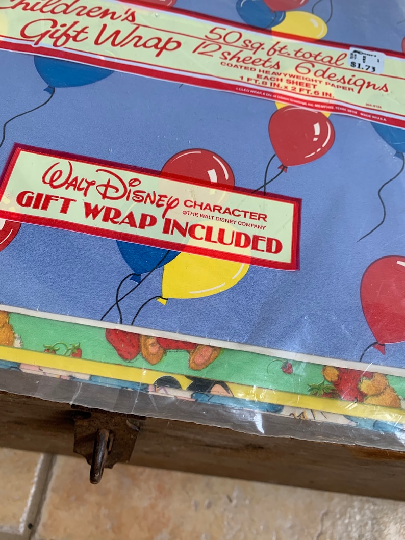 May include: A pack of Walt Disney character gift wrap featuring balloons and a blue background. The pack includes 12 sheets of wrapping paper, each measuring 1 foot 8 inches by 2 feet 6 inches, for a total of 50 square feet. The price is &pound;1.73.