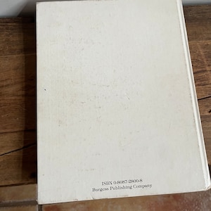 May include: White book with the text "ISBN 0-8087-2800-8 Burgess Publishing Company" printed on the back cover.