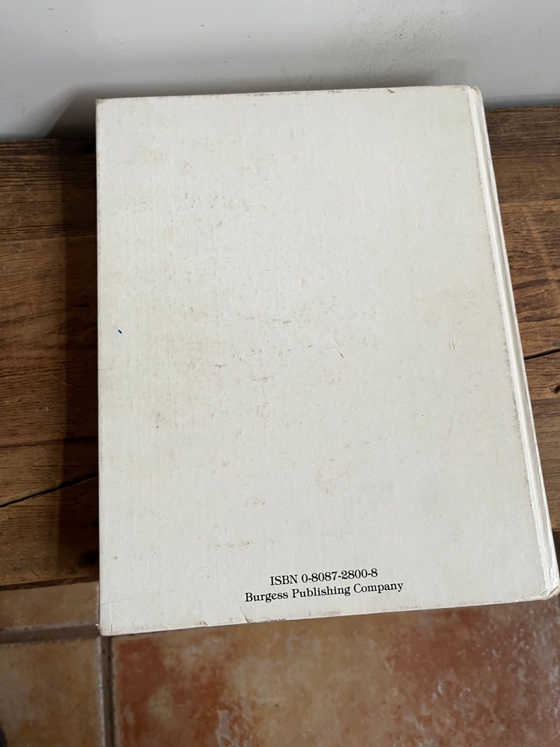 May include: White book with the text "ISBN 0-8087-2800-8 Burgess Publishing Company" printed on the back cover.