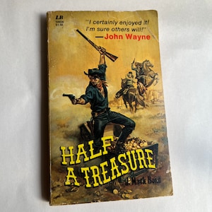 May include: A vintage paperback book cover with a yellow and black illustration of a cowboy holding a gun and standing on a treasure chest. The book title is "Half A Treasure" by J. Mark Bond. The quote "I certainly enjoyed it! I'm sure others will!" - John Wayne is printed on the cover.